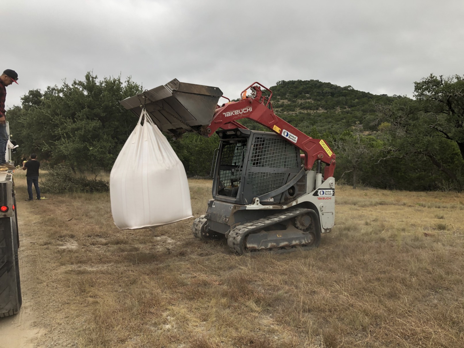 unloading flatbed Unloading bulk bentonite super sacks from a flatbed truck