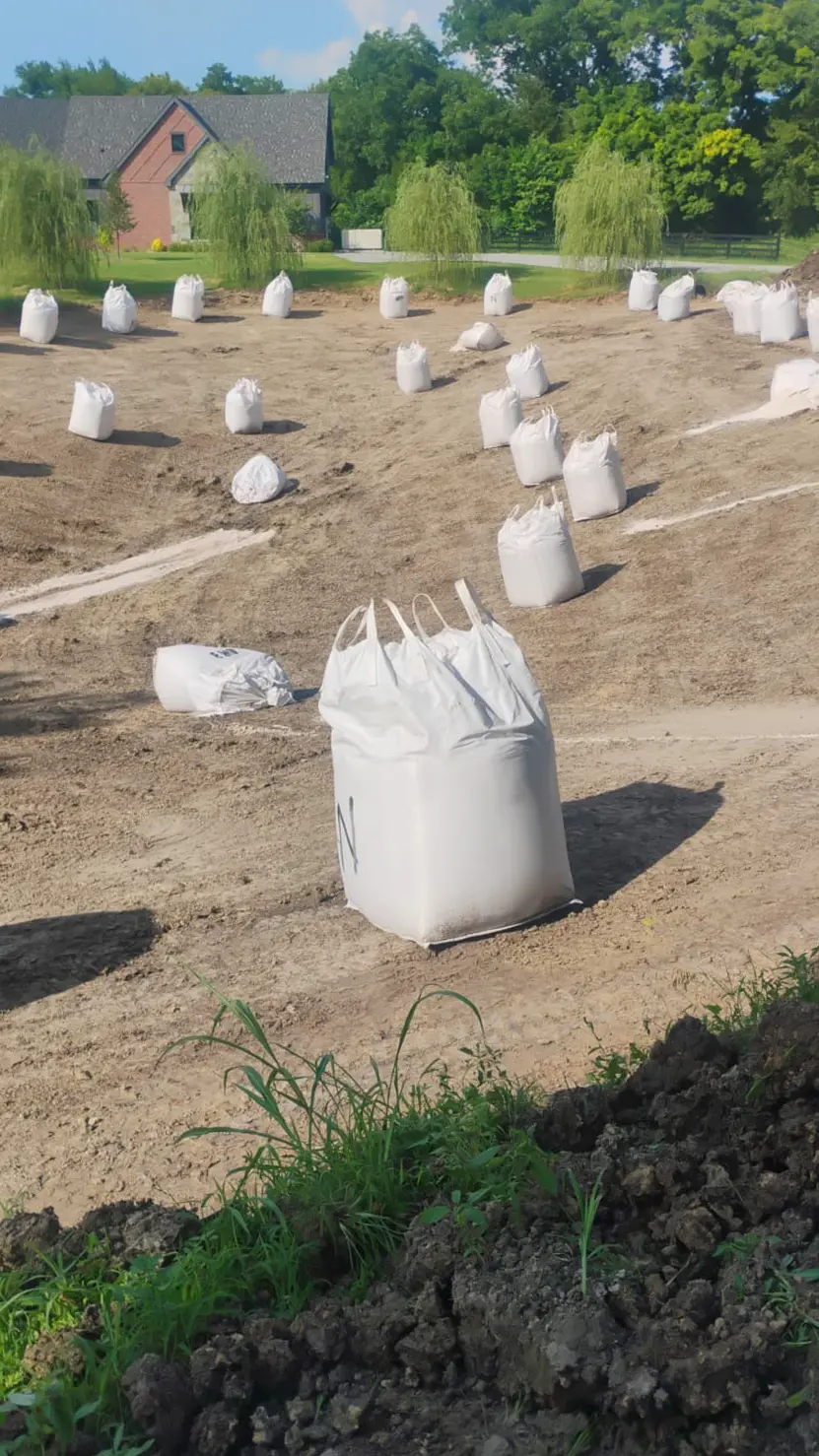 residential-pond-installing-bentonite Applying bentonite to a residential pond